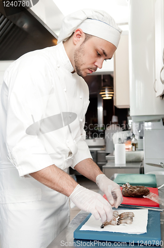 Image of chef preparing shrimps on board