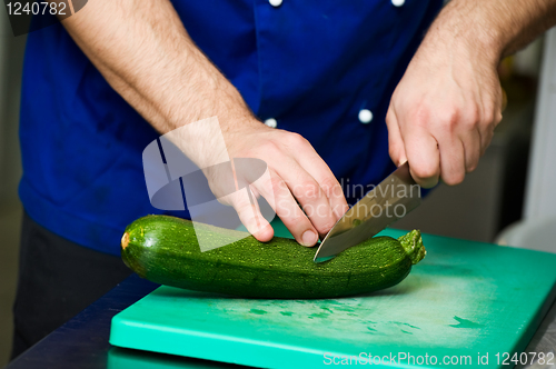 Image of cutting green marrow on board