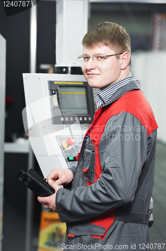 Image of worker at machining tool workshop