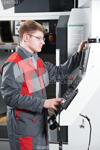 Image of worker at machining tool workshop