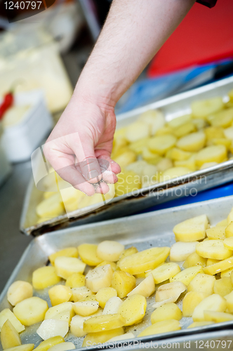 Image of Cooking - adding salt and spicery