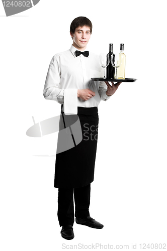 Image of Waiter sommelier with bottles of wine and stemware on tray