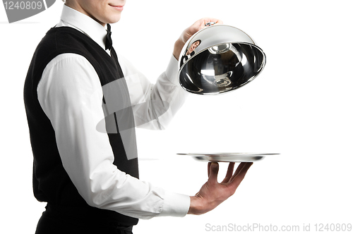 Image of hands of waiter with cloche lid cover