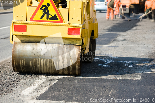 Image of Asphalt paving works with compactor