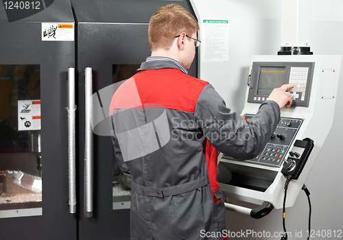 Image of worker at machining tool workshop