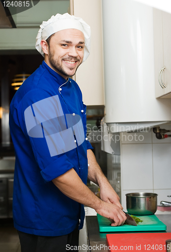 Image of chef cutting greens