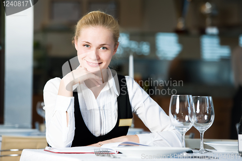 Image of restaurant manager woman at work place