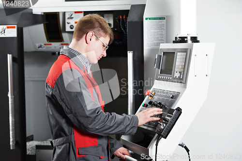 Image of worker at machining tool workshop