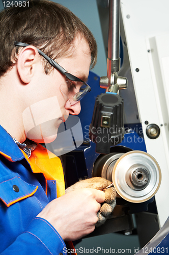 Image of worker at machine tool operating