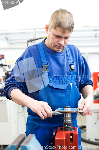 Image of worker checking cutting tool