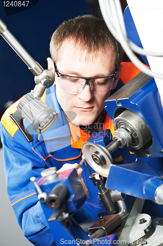 Image of worker at machine tool operating