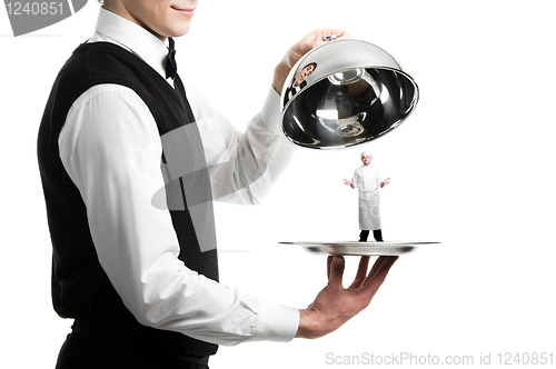 Image of hands of waiter with cloche and chef