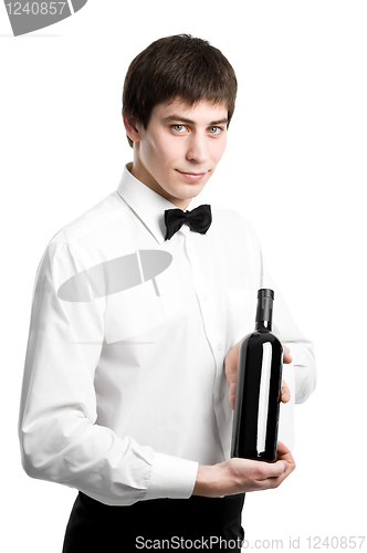 Image of Waiter sommelier with wine bottle and stemware