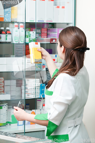 Image of Pharmacy chemist woman in drugstore