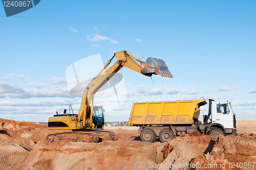 Image of excavator and dumper truck