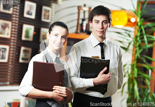 Image of Waitress girl and waiter man in restaurant