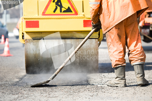 Image of Asphalt paving works with compactor