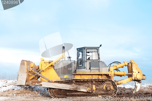 Image of bulldozer loader at winter frozen soil works