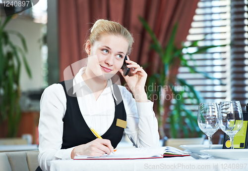 Image of restaurant manager woman at work place