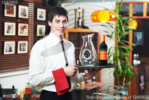 Image of waiter in uniform at restaurant