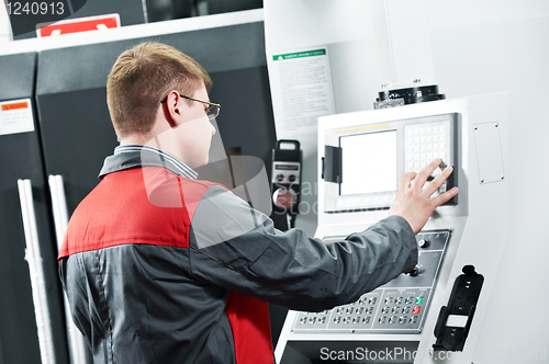 Image of worker at machining tool workshop