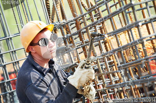 Image of construction worker with flame cutting equipment