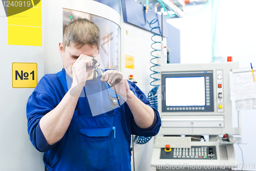 Image of worker measuring detail