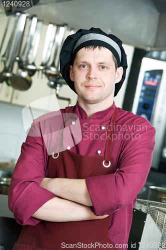 Image of chef in uniform at kitchen