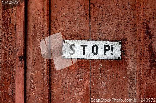 Image of a sign saying ''stop''on the grunge wooden background 