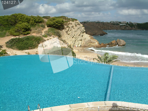 Image of swimming pool next to the ocean