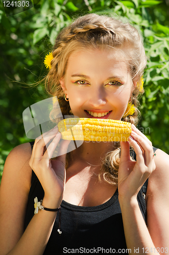 Image of woman eating corn-cob