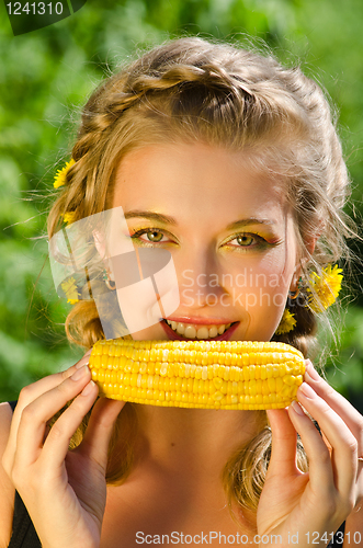 Image of woman eating corn-cob