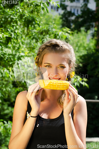 Image of woman eating corn-cob
