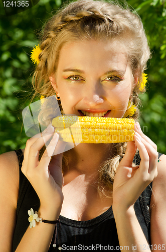 Image of woman eating corn-cob