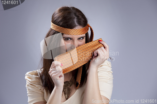 Image of Woman hidding behind a necktie