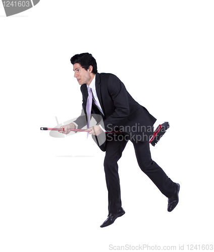 Image of Businessman flying a broom