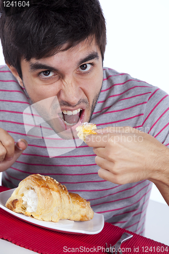 Image of Man eating a cake