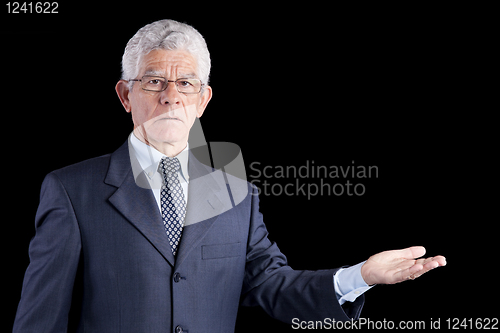 Image of Senior businessman showing something