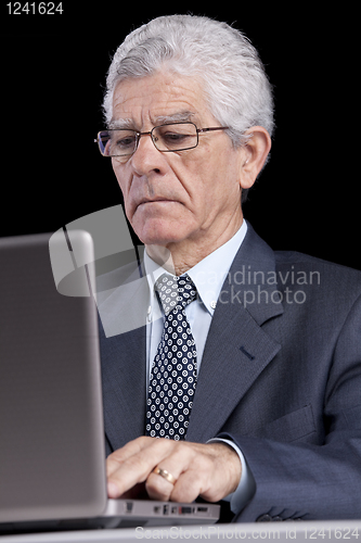 Image of Senior businessman at the office