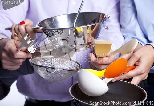 Image of Hands holding kitchenware tools