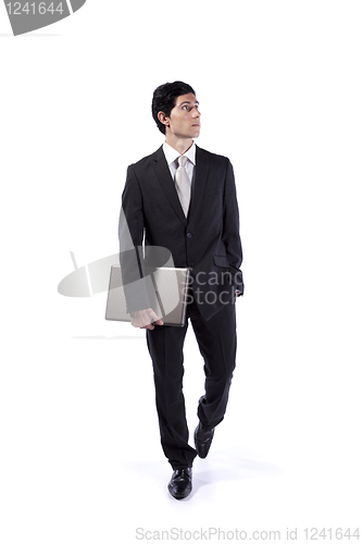 Image of Businessman walking and looking up