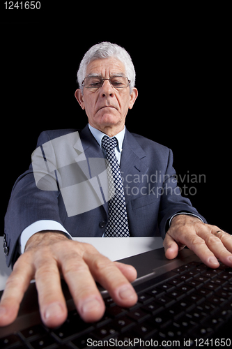 Image of Senior businessman at the office