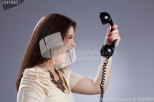 Image of Angry woman screaming to the telephone