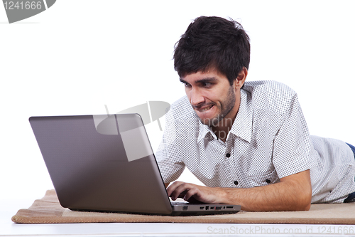 Image of Happy young man surfing the internet