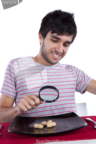 Image of Man looking to a peanut