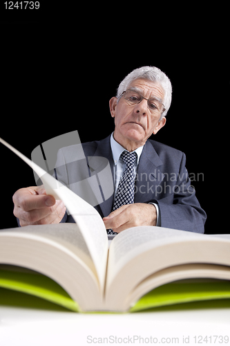 Image of Senior businessman reading a book