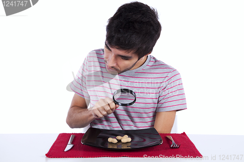 Image of Man looking to a peanut