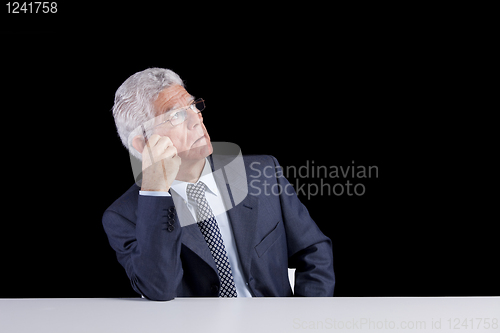 Image of Senior businessman looking up