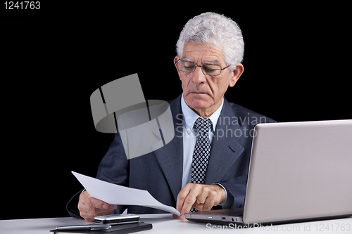 Image of Senior businessman at the office
