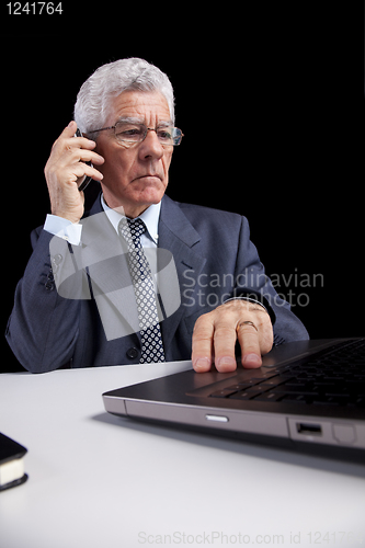 Image of Senior Businessman talking at the cellphone